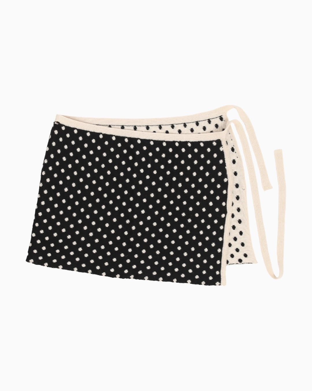 Knitwear skirt with light polka dots on a dark fabric, packshort with white background