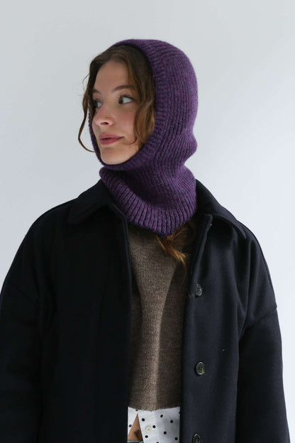 Portrait of a woman wearing a purple balaclava