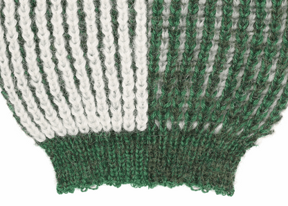 the sleeve detail of an alpaca knit white and green sleeve