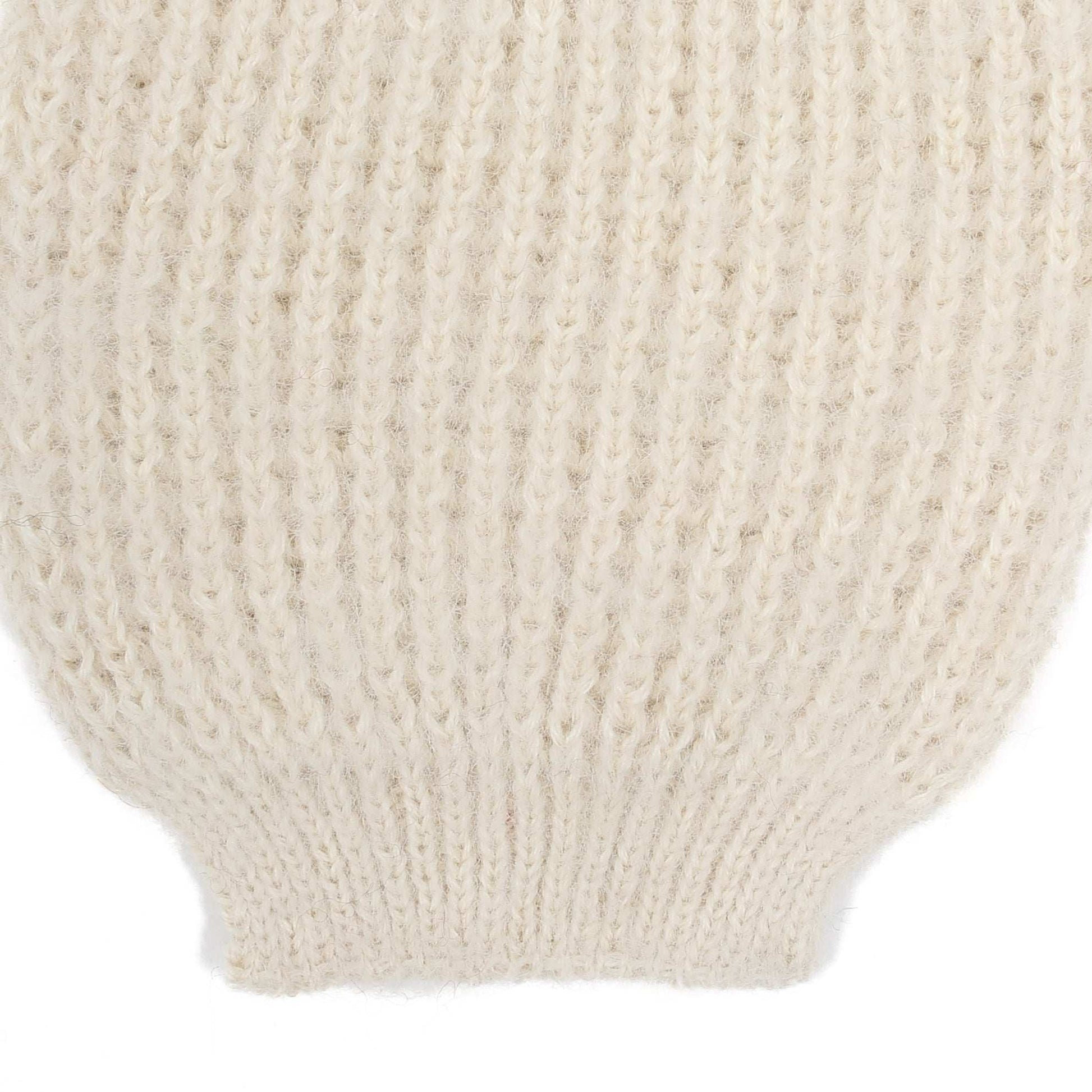 the sleeve detail of an alpaca ribbed knit white sleeve