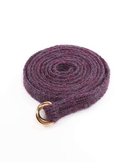 Purple knit belt with double golden buckles on a white. background